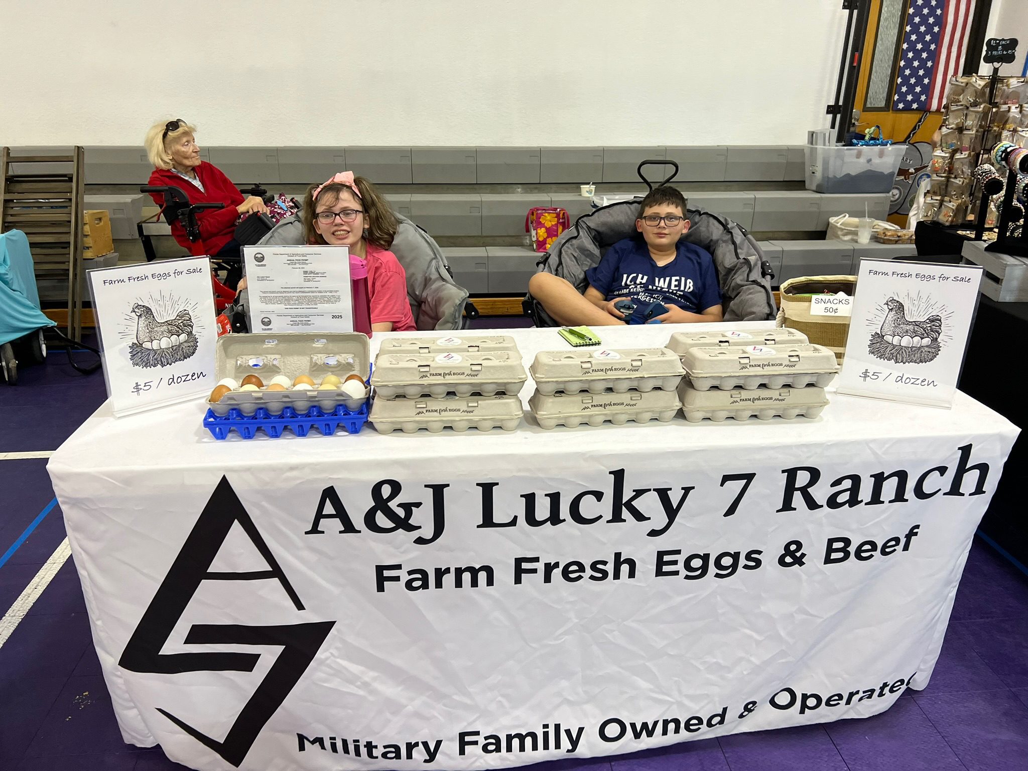A&J Lucky 7 Ranch selling farm fresh eggs and baked goods at a market.
